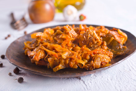 Stewed or braised cabbage served on dark plate, close upの写真素材