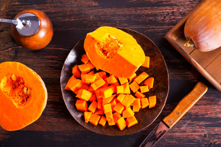 raw pumpkin, fresh pumpkin on plate on a tableの写真素材