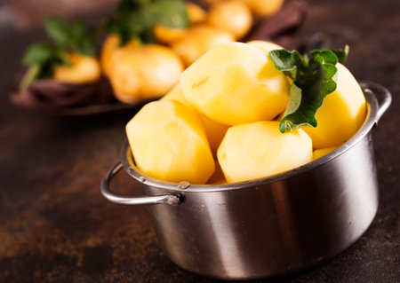 Raw potatoes. Fresh potatoes on dark background.の写真素材