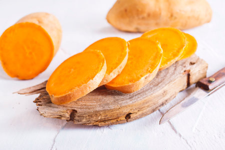 fresh sweet potatoes on a light background.の写真素材