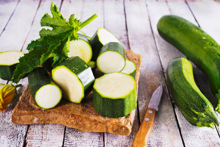 Slicing zucchini on a cutting board.の写真素材