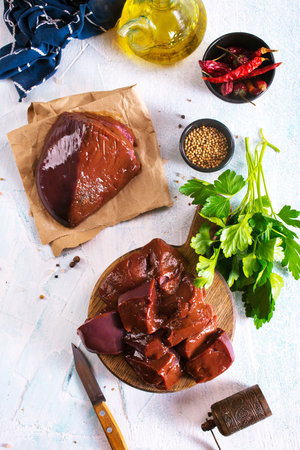 Raw Beef liver meat on wooden cutting boardの写真素材