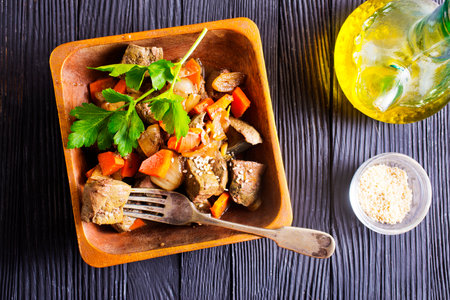 Fried chicken liver with onions and carrots in bowlの写真素材