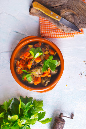 Fried chicken liver with onions and carrots in bowlの写真素材