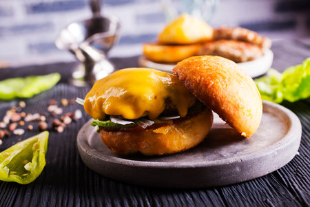 Cheese beef burger with a lettuce. Burger with meat. Junk fast food. Cooking a burger at home.の写真素材