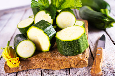 Slicing zucchini on a cutting board.の写真素材