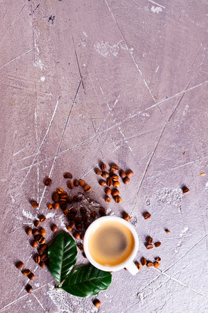 Coffee cup and coffee beans on gray backgroundの写真素材