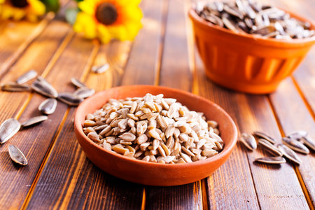 Shelled sunflower seeds in bowlの写真素材