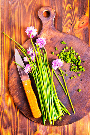 fresh onion and flowers on cutting boardの写真素材