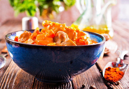 Chicken curry served in bowl on a tableの写真素材