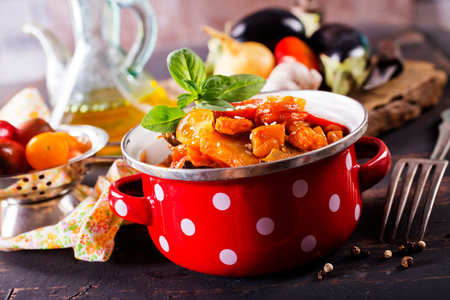 vegetable stew with tomato sauce in red bowlの写真素材