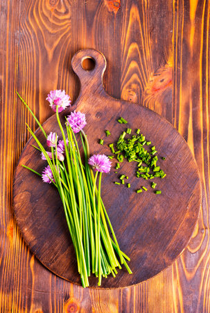 fresh onion and flowers on cutting board