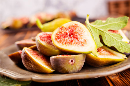 Ripe figs on wooden table, flat lay. Space for text