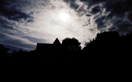 Silhouette of a country house at duskの写真素材