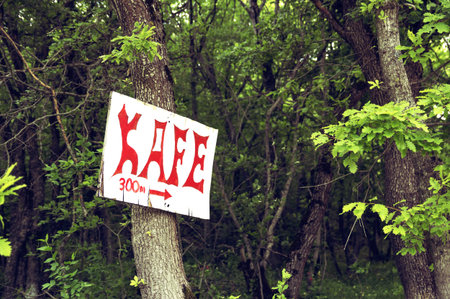 Plate with a pointer to the cafe in the forest