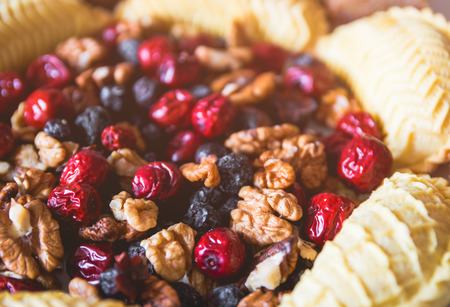 Sweets and desserts for the Novruz holiday on plate - shekerbura, baklava, walnuts and dried fruitsの写真素材