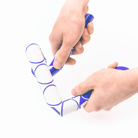 Puzzle snake toy in hands isolated on white backgroundの写真素材