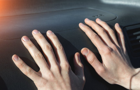 Hands on the airbag in the car salon