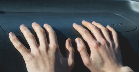 Hands on the airbag in the car salonの写真素材
