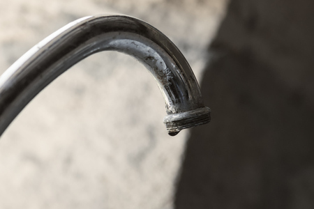 Water tap with peeling coating, close-up photoの写真素材