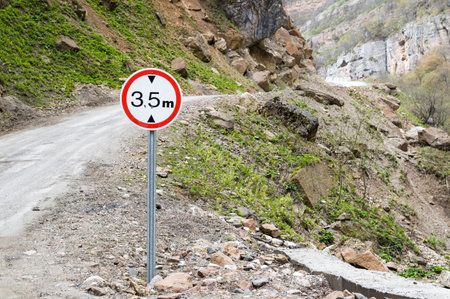 Road sign limiting altitude on a mountain road