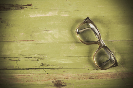 Old glasses on a green wooden backgroundの写真素材