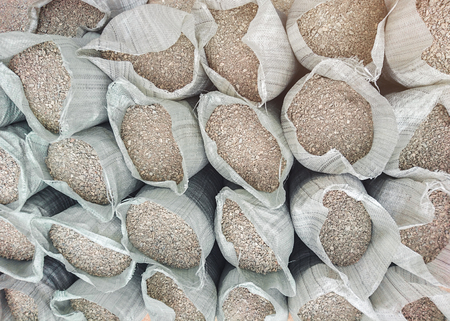 Sacks with building materials - sand and gravel, arranged in a rowの写真素材