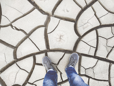Walking on the dried ground with cracksの写真素材
