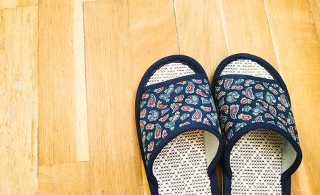 Home slippers on the parquet backgroundの写真素材