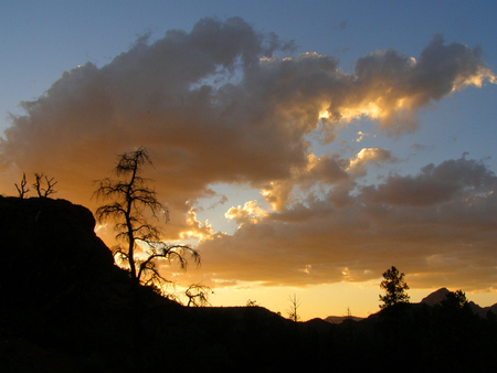 A bright yellow colored sunset on clouds above the Broken Arrow Trail in Sedona, Arizona.の写真素材