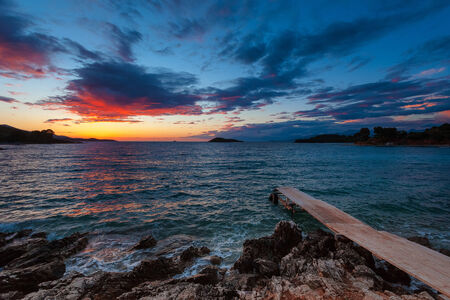 Beautiful sea sunset on the rocky coastline.の写真素材