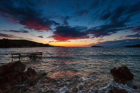 Colored sea sunset on the rocky coastline.の写真素材