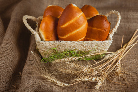 Gold and browm buns in the busket. Ripe ears.の写真素材