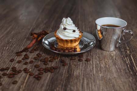 Cake with cream on a plate. Cup of cofee.の写真素材
