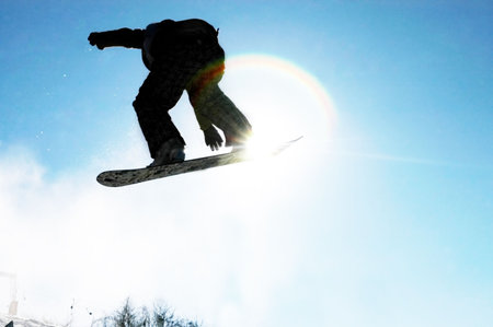 A snowboarder going big high above the half pipe                                     の写真素材