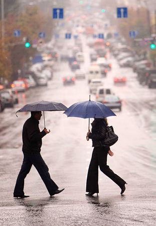 urban people cross the street on the rainの写真素材