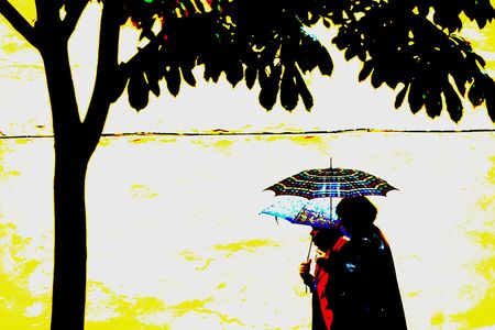 couple under umbrela walkingの写真素材