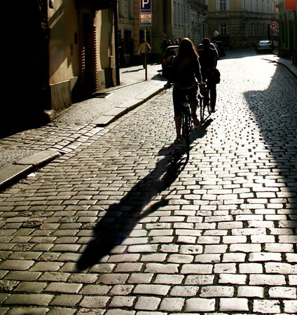 Silhouette of a people riding  by bycicle. Prague. Czech Republicの写真素材
