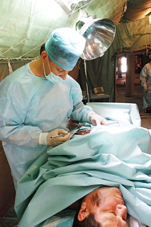 KYIV REGION, UKRAINE - MAY 24, : surgeons in operative room in military mobile hospital during a medical military trainings on May 24, 2007 in Kyiv region, Ukraineのeditorial素材
