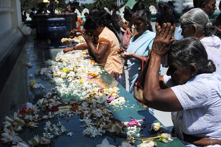 Dambulla, Sri Lanka - Feb 17, 2011:Sri Lankan people praying at Dambulla Golden Temple - It is the largest and best-preserved cave temple complex in Sri Lanka and World Heritage Site (1991) .のeditorial素材