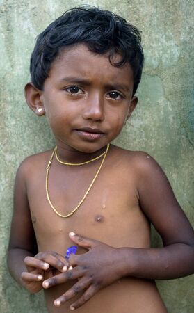 Neluwa; Sri Lanka - January 27; 2011: Portrait of a littlel Sri Lankan girl  from small village in Sinharaja Rain Forest. Sinharaja Rain Forest is the last viable area of primary tropical rainforest in Sri Lanka. The Rain Forest is a UNESCO World Natural のeditorial素材