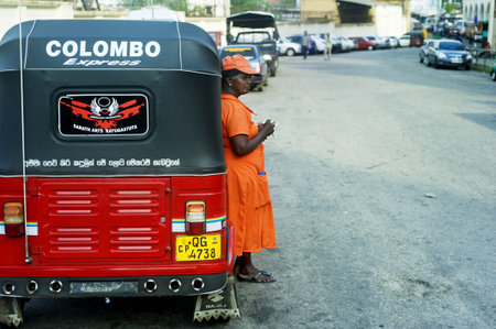 Colombo, Sri Lanka - February 22, 2011: Worker of Sri Lankan traditional taxi(tuk-tuk) waiting for clients.のeditorial素材