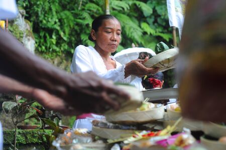 Ubud, Bali island, Indonesia - April, 06, 2011: Unidentified local woman wearing in traditional indonesian clothes take part in Buda Wage Kelawu ceremony at Hindu temple.のeditorial素材
