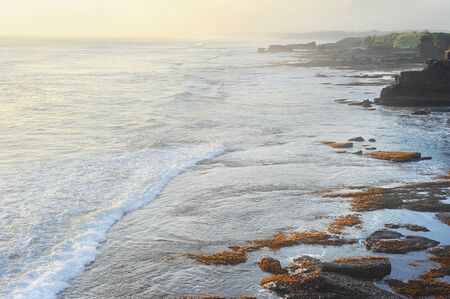 Beautiful sunset on the ocean beach in Bali island, Indonesiaの写真素材