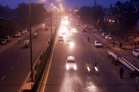Delhi, India - February 29, 2012: Traffic  on the road at night  in Delhi. As of 2011, India has a total of 70,934 km (44,076 mi) of National Highways, of which 200 km (124 mi) are classified as expresswaysのeditorial素材