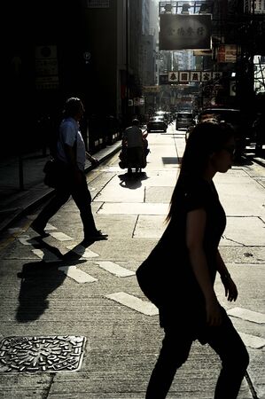 Hong Kong S.A.R. - MAY 22, 2012: People crossing in Hong Kong.  With a land mass of 1,104 km and population of 7 million people, Hong Kong is one of the most densely populated areas in the worldのeditorial素材