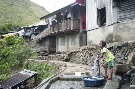 Sagada, Philippines - March 23, 2012:  Girl washing clothes in the small village in Philippines.  About 12 per cent of Philippines children between the ages of five and 14 are forced to work. のeditorial素材