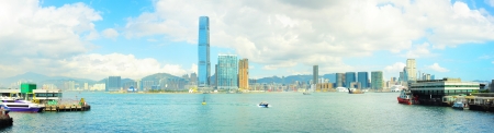 View from Hong Kong to Kowloon island in the sunshine day. Ferry piers on both side of picture.の写真素材