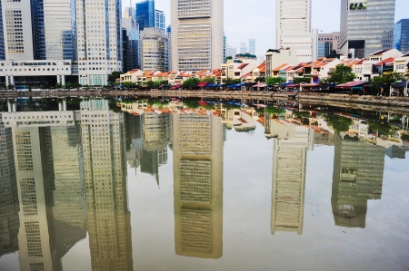 Boat quay in Singapore with reflection in a riverの写真素材