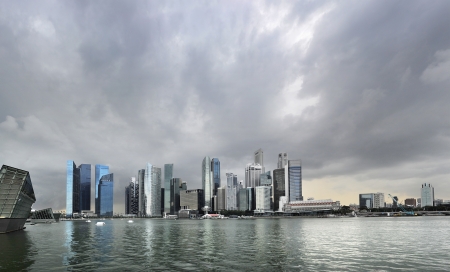 Skyline of Singapore with a dark stormy sky の写真素材